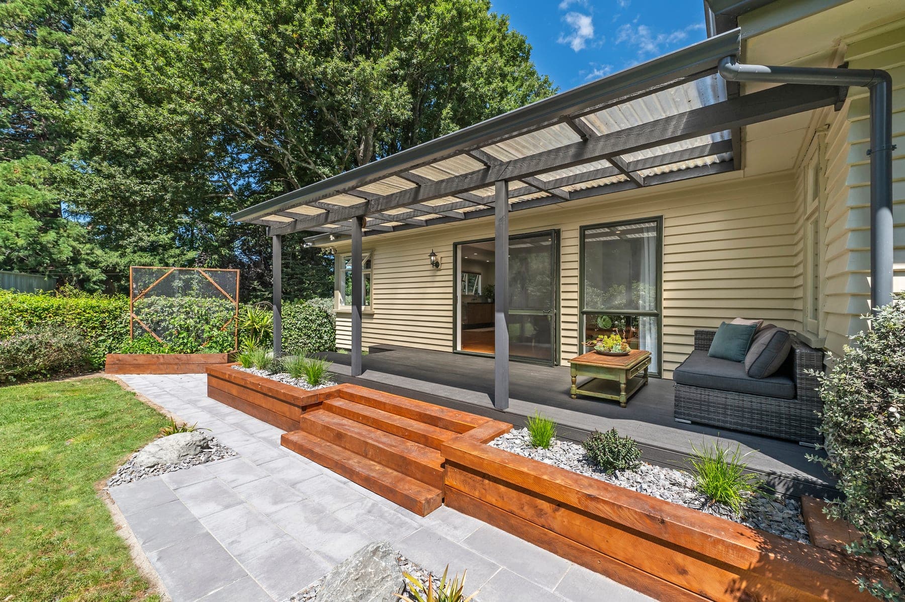 Covered deck overlooking lush garden